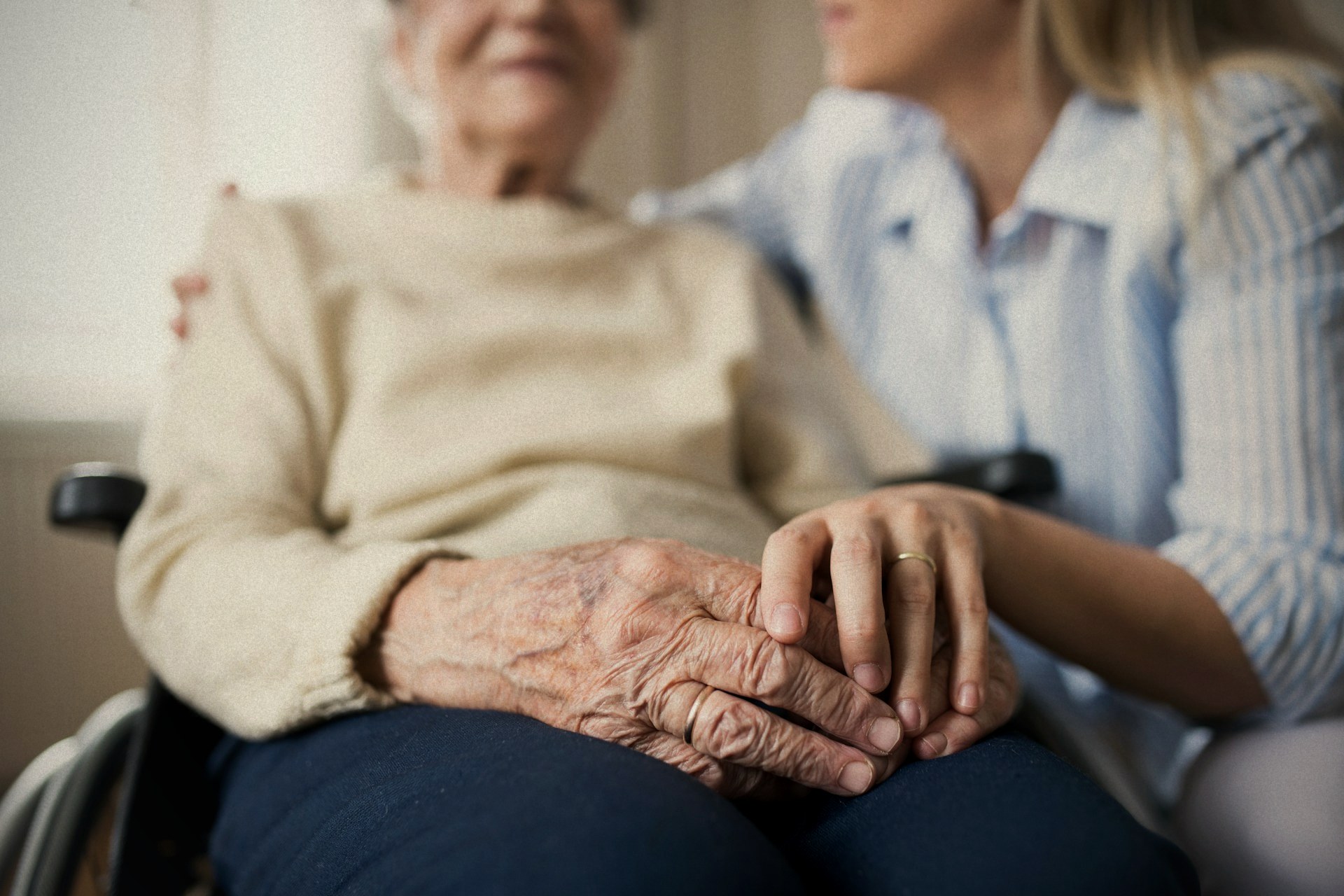 A Nurses & Company caregiver sitting with a resident