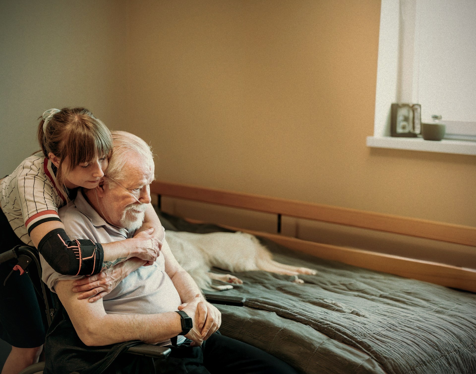 A Nurses & Company caregiver comforting an older adult at home